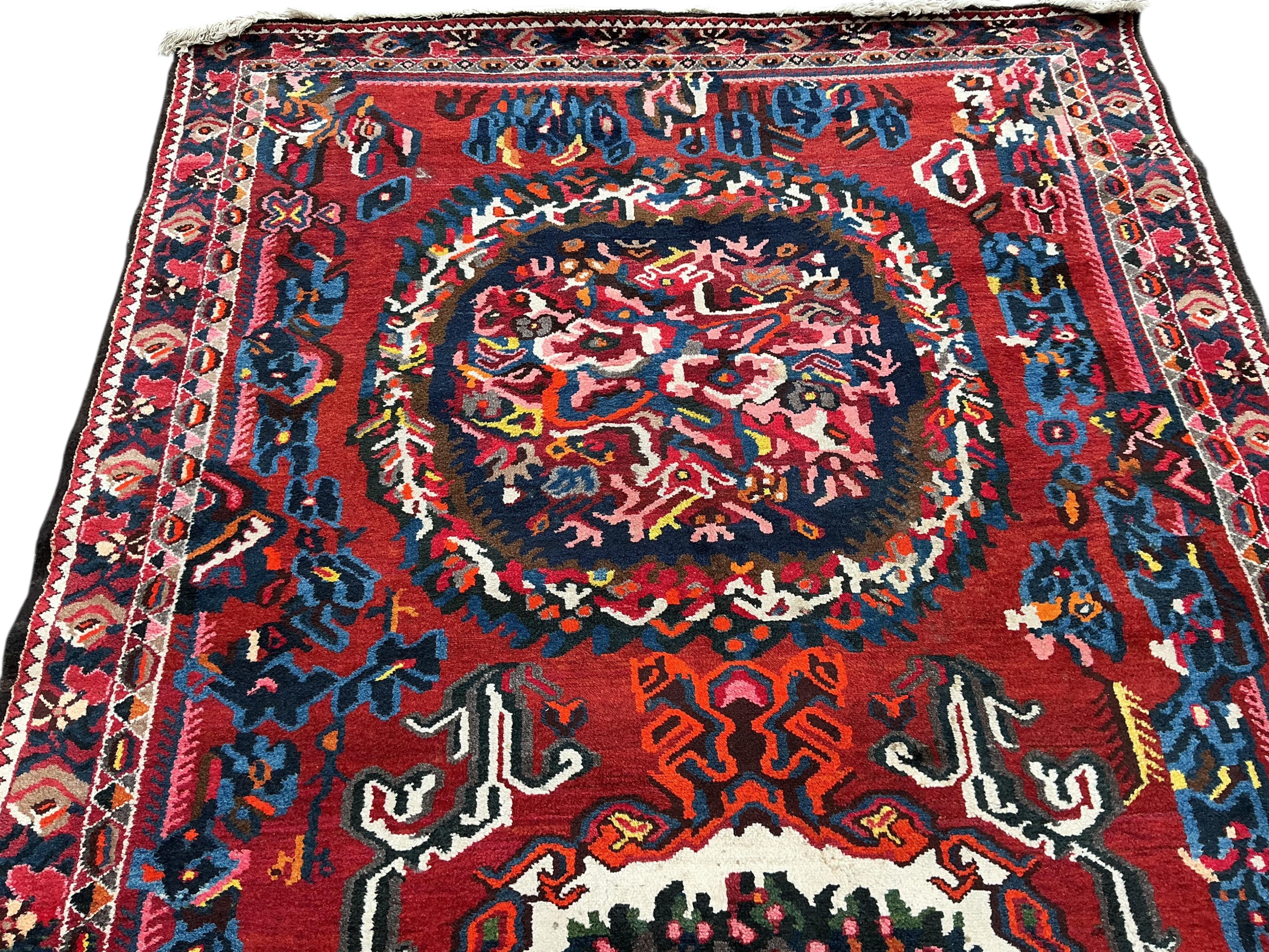 A Baktiari red ground carpet, 390 x 170cm